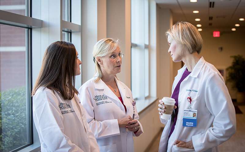 Three female health care professionals talking