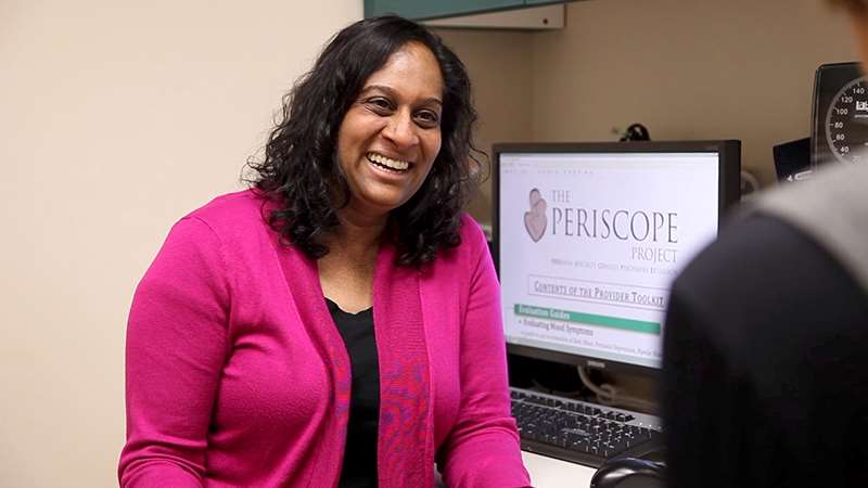 Female doctor with female patient in office